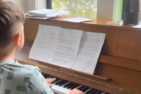 Young student practicing piano technique during individual lesson at The Starlight Piano Academy