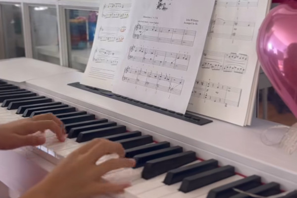 Family duo program session with parent and child learning piano together in Tysons Corner Virginia